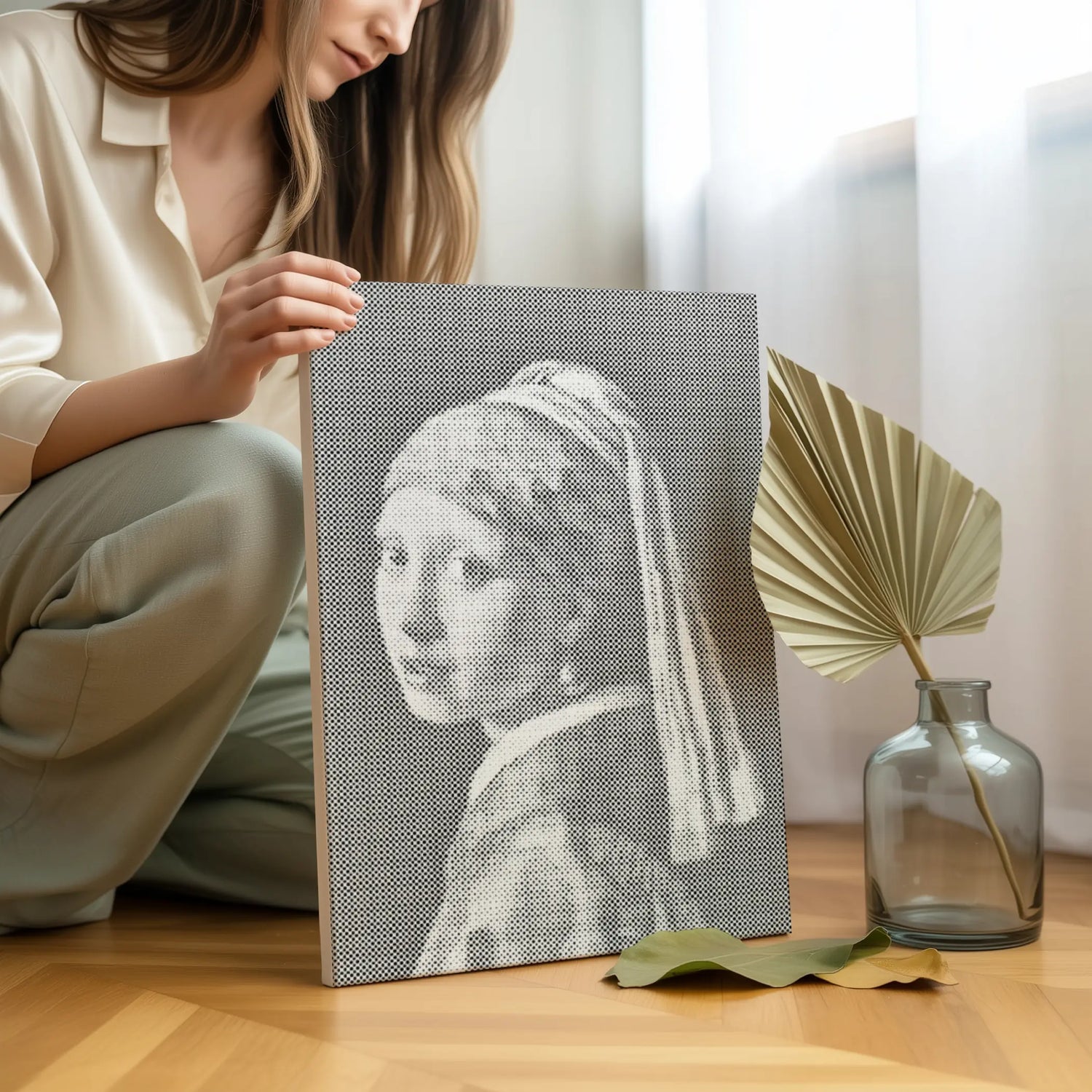 Person holding a woven art piece of 'Girl with a Pearl Earring' by Vermeer on a wooden floor. Famous Artwork Dot Paintings