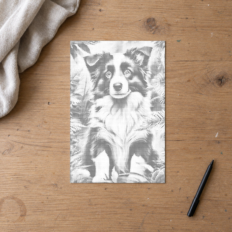 Toile de peinture par points “Chiot border collie”, vue du dessus sur une table de travail à la lumière douce du jour.