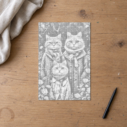 Toile de peinture par points “Famille de chats”, vue du dessus sur une table de travail à la lumière douce du jour.