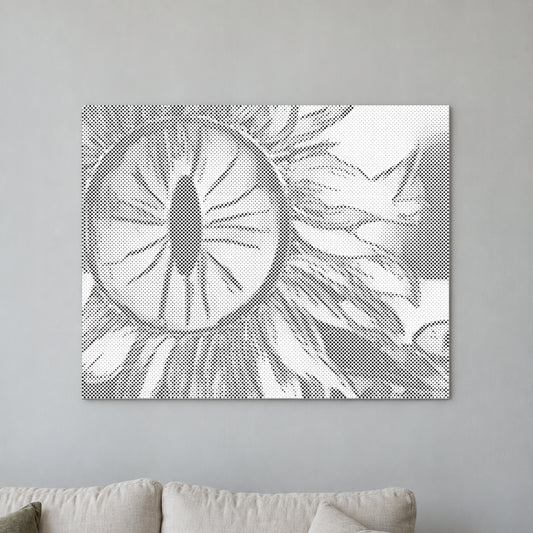 Toile de peinture par points “Œil tournesol”, sur un mur clair dans une pièce baignée d’une lumière douce.